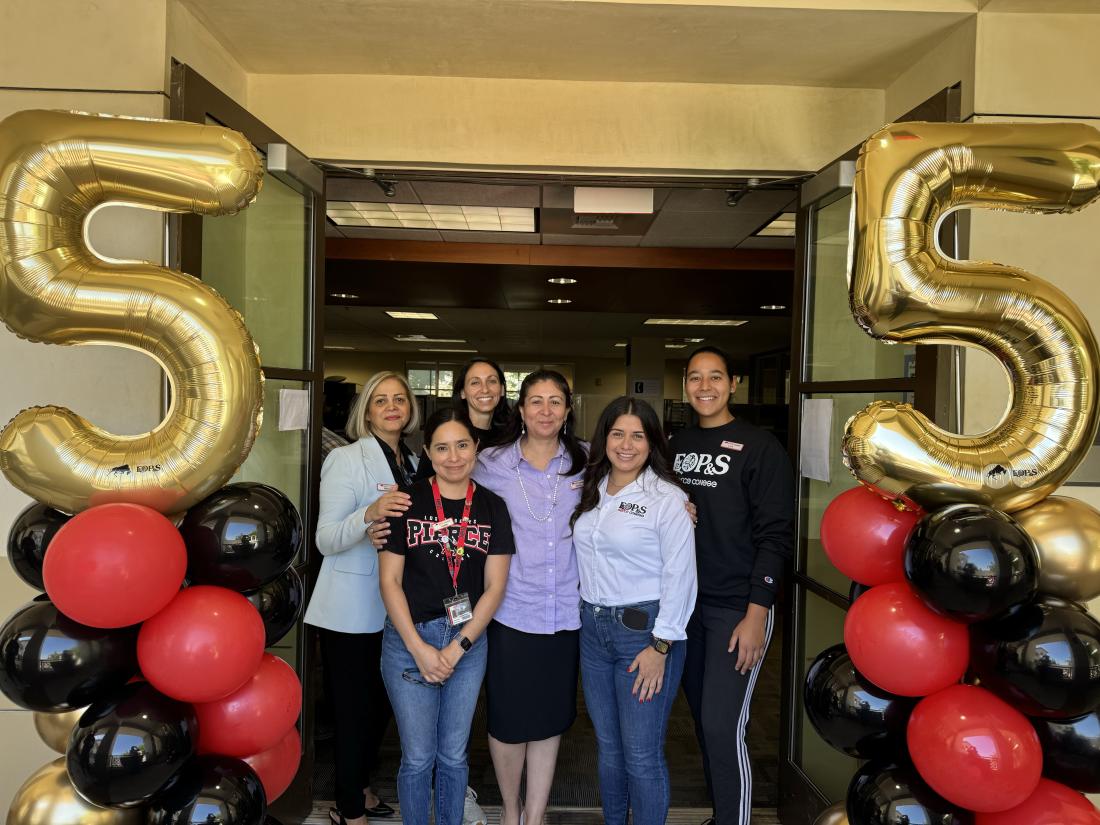 EOPS Office posing next to celebratory balloons