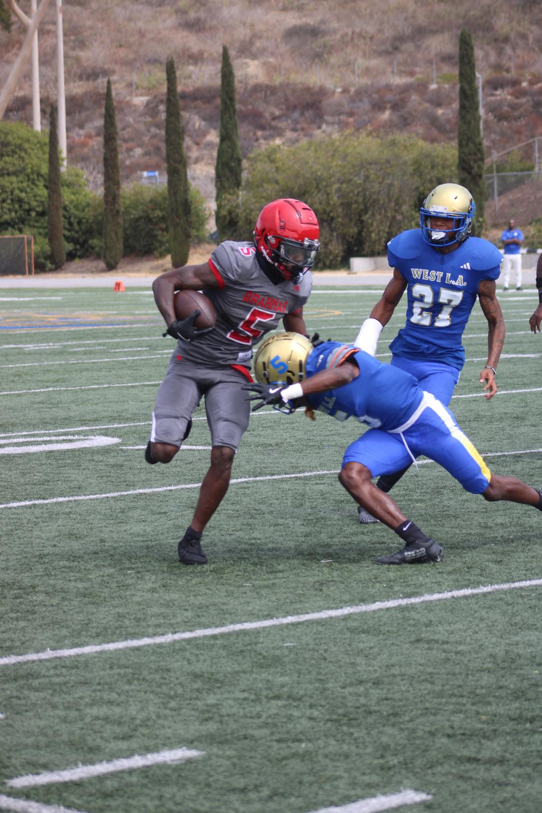 Three football players tackling